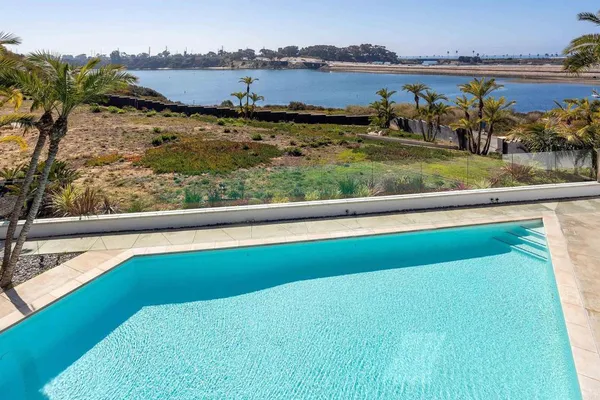 a living room with patio furniture and a floor to ceiling window