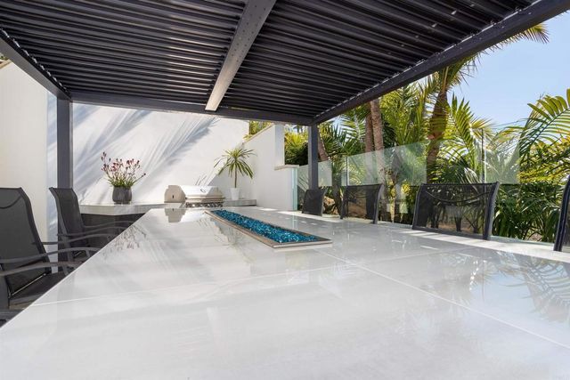 a bedroom with a bed a flat screen tv and a large window