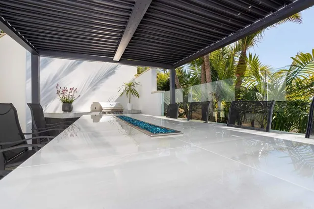 a bedroom with a bed a flat screen tv and a large window