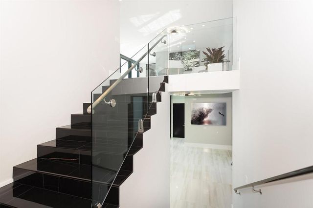 a kitchen with stainless steel appliances granite countertop a stove and a wooden floors