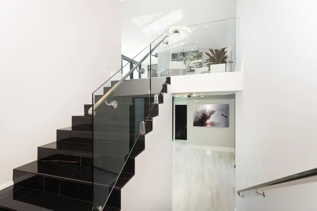 a kitchen with stainless steel appliances granite countertop a stove and a wooden floors