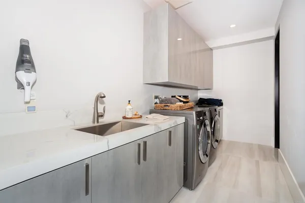 a kitchen with stainless steel appliances kitchen island granite countertop a sink and a refrigerator