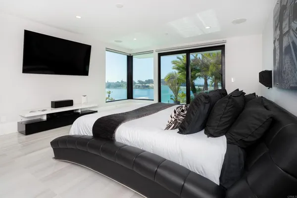 a bedroom with a bed and a flat screen tv