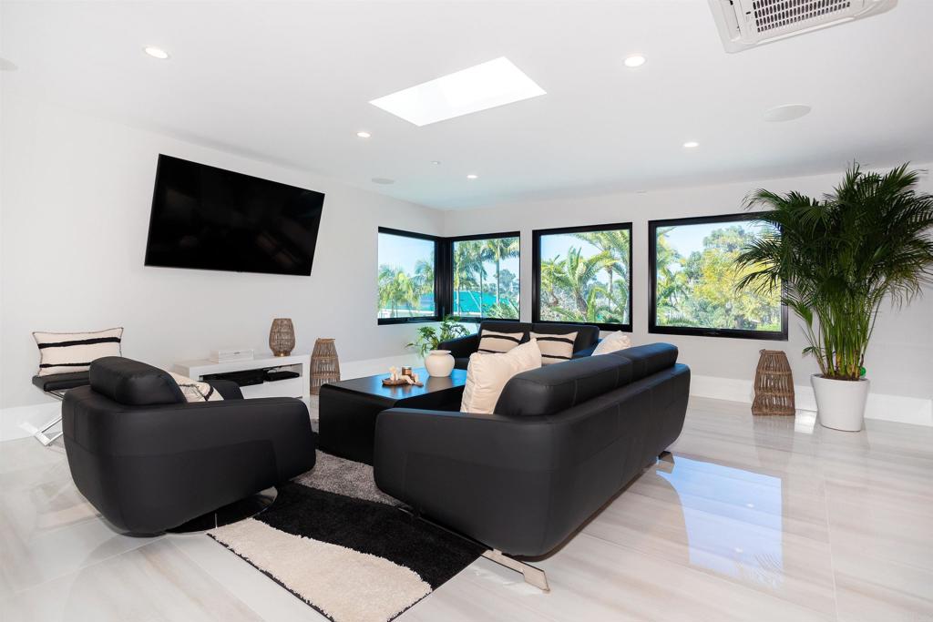 1095 Hoover Street Carlsbad, CA 92008 - Photo 67 of 75 a living room with furniture and a flat screen tv