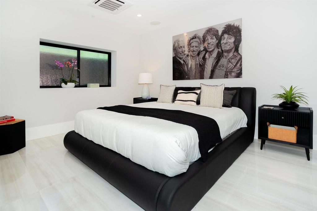 1095 Hoover Street Carlsbad, CA 92008 - Photo 68 of 75 a bedroom with a bed and a flat screen tv