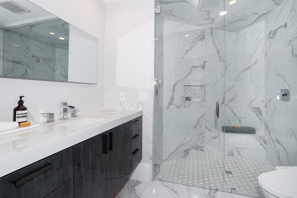 1095 Hoover Street Carlsbad, CA 92008 - Photo 69 of 75 a bathroom with a sink a toilet and shower