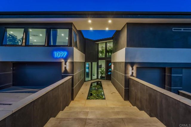 a kitchen with a sink dining table and chairs