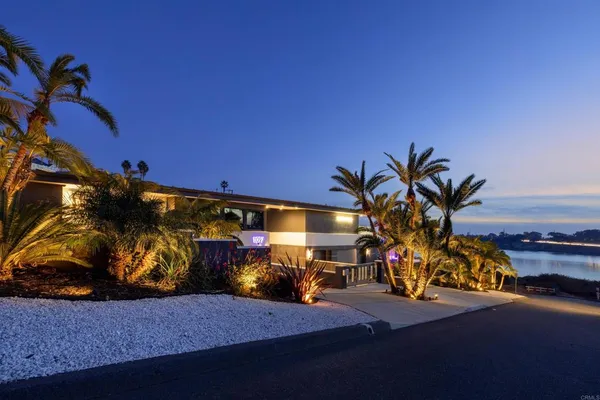 a kitchen with a sink dining table and chairs