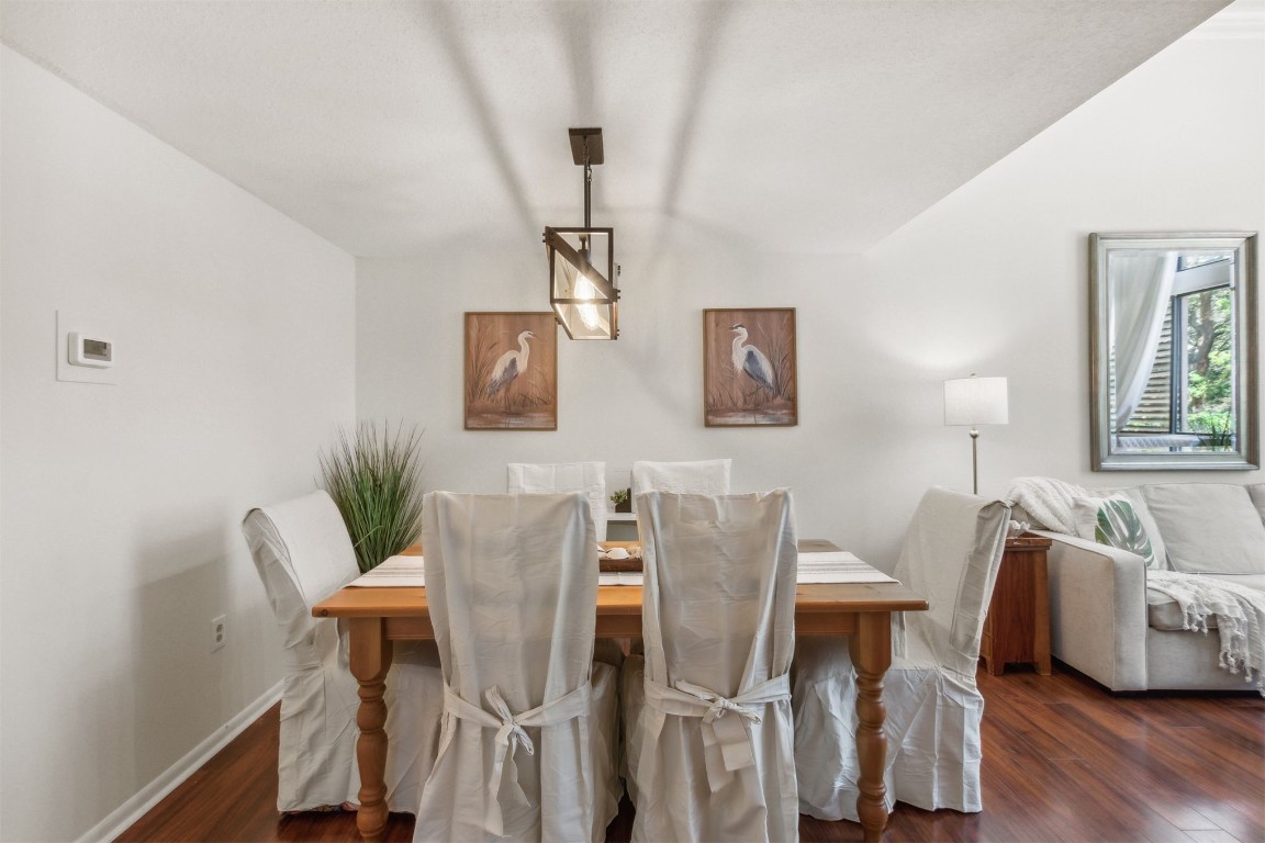 1163 Beach Walker Road, Unit 1163 Fernandina Beach, FL 32034 - Photo 13 of 52 a view of a dining room with furniture and wooden floor