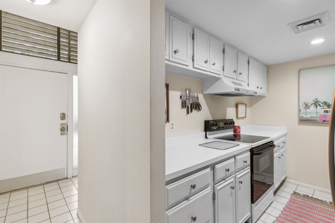 1163 Beach Walker Road, Unit 1163 Fernandina Beach, FL 32034 - Photo 15 of 52 a kitchen with stainless steel appliances granite countertop a sink and cabinets