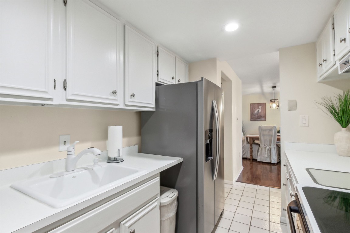 1163 Beach Walker Road, Unit 1163 Fernandina Beach, FL 32034 - Photo 16 of 52 a kitchen with stainless steel appliances a refrigerator sink and cabinets