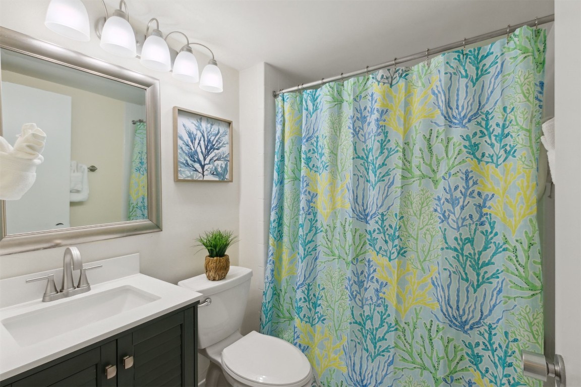 1163 Beach Walker Road, Unit 1163 Fernandina Beach, FL 32034 - Photo 17 of 52 a bathroom with a sink and mirror with toilet