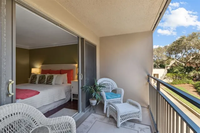 a bedroom with a bed and a large window with outer view