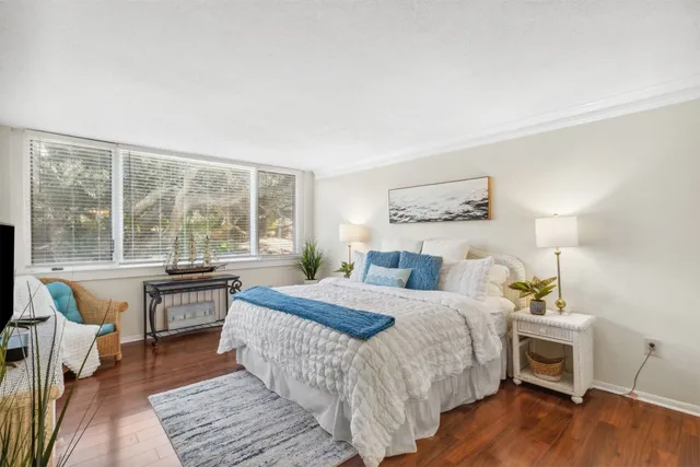 a bathroom with a granite countertop toilet sink and mirror