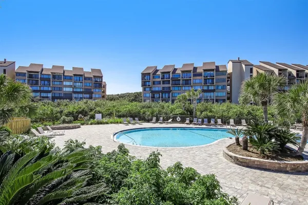 a view of a patio with table and chairs and potted plants with wooden floor and fence