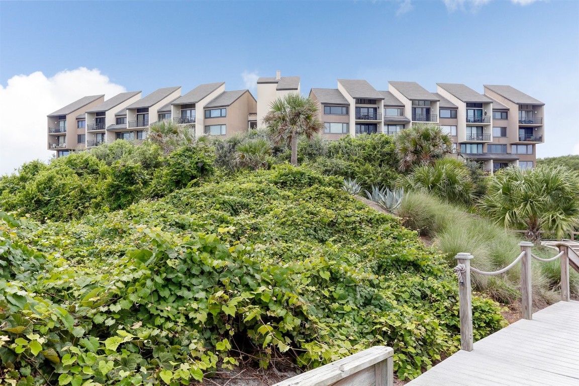 1163 Beach Walker Road, Unit 1163 Fernandina Beach, FL 32034 - Photo 40 of 52 a front view of a house with a yard and trees