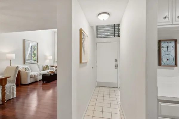 a living room with furniture a large window and a flat screen tv