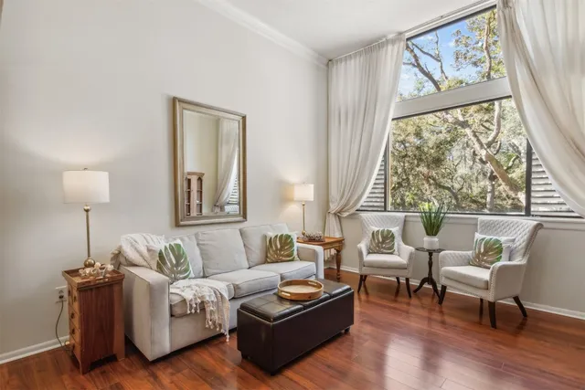 a living room with furniture and a book shelf
