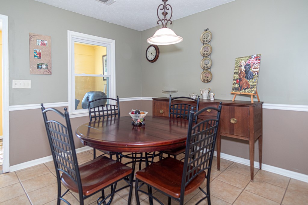 5399 Sandfort Road Seale, AL 36875 - Photo 9 of 33 a view of a dining room with furniture and chandelier
