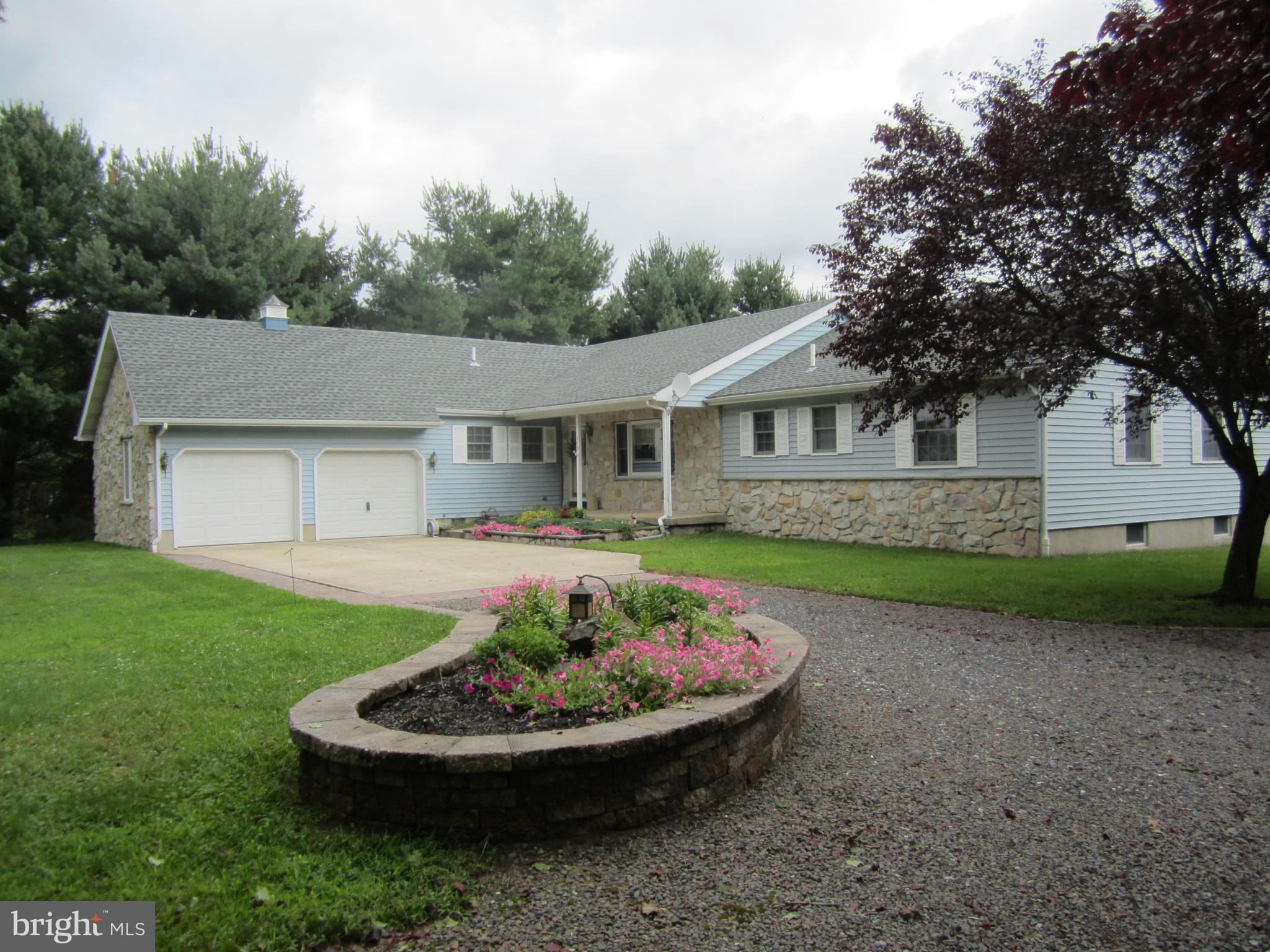 348 Eayrestown Road Southampton, NJ 08088 - Photo 1 of 32 a front view of a house with a garden and trees