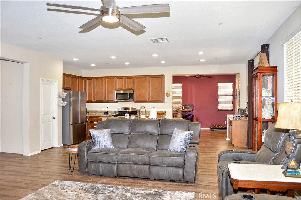 166 Fox Lane Calimesa, CA 92320 - Photo 16 of 76 Spacious Great-Room-Style Living Room with Fabulous Flooring, Ceiling Fan, and Backyard Views