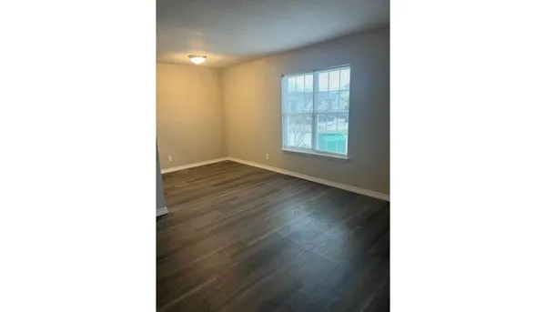 a view of a room with a ceiling fan and a window