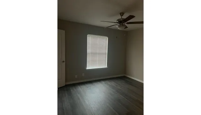 a front view of a house with a garden and yard