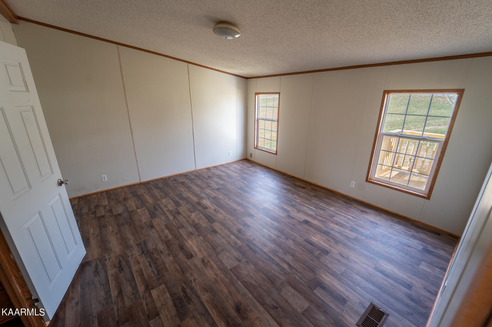 560 Meadowview Road Mosheim, TN 37818 - Photo 13 of 23 a view of an empty room with wooden floor and a window