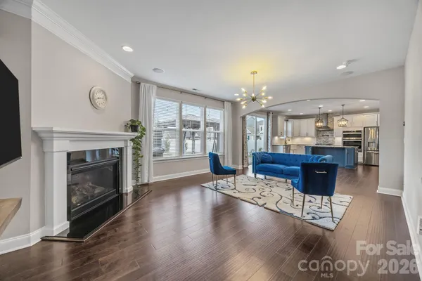 a living room with fireplace furniture and a wooden floor