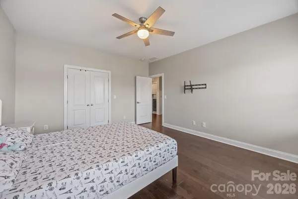 a bedroom with a bed and a painting on the wall