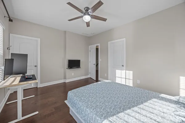 a bedroom with a bed and a flat screen tv