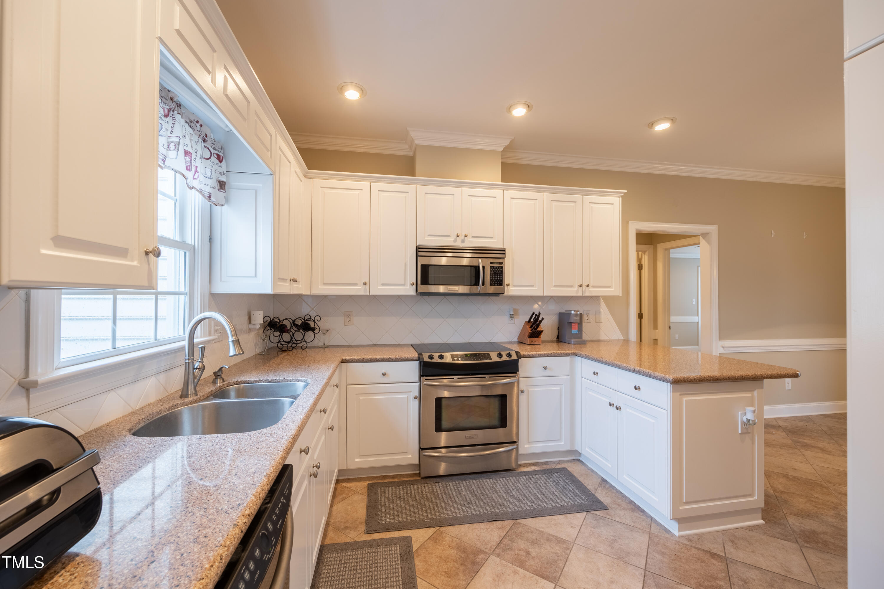 5148 Nowell Road Sims, NC 27880 - Photo 20 of 49 a kitchen with granite countertop a sink counter top space appliances and cabinets