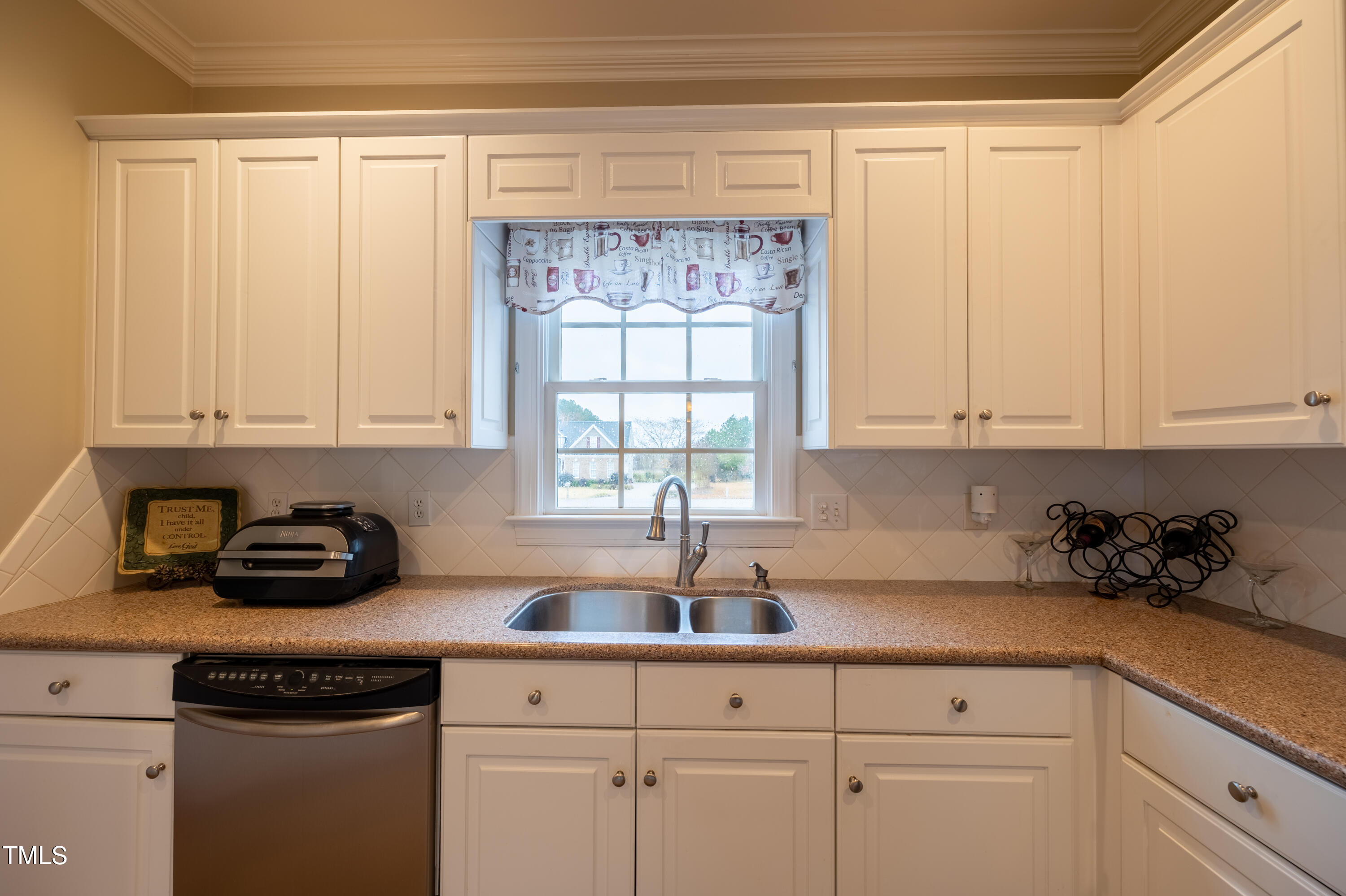 5148 Nowell Road Sims, NC 27880 - Photo 21 of 49 a kitchen with white cabinets and a window