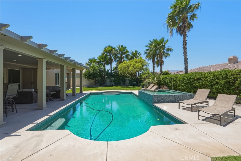 9 Orleans Road Rancho Mirage, CA 92270 - Photo 56 of 71 a view of a swimming pool with lounge chair