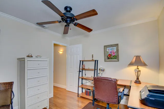 a view of a workspace with furniture and a window