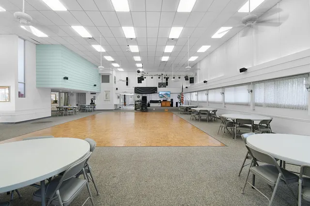 a view of swimming pool with outdoor seating and lake view