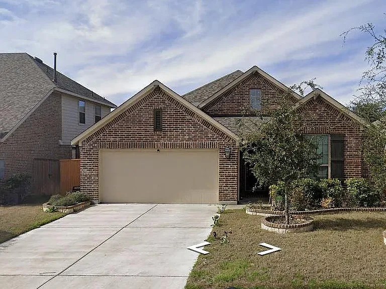 616 Garner Park Drive Georgetown, TX 78628 - Photo 11 of 26 View of front of house with brick siding, driveway, a garage, and a front yard