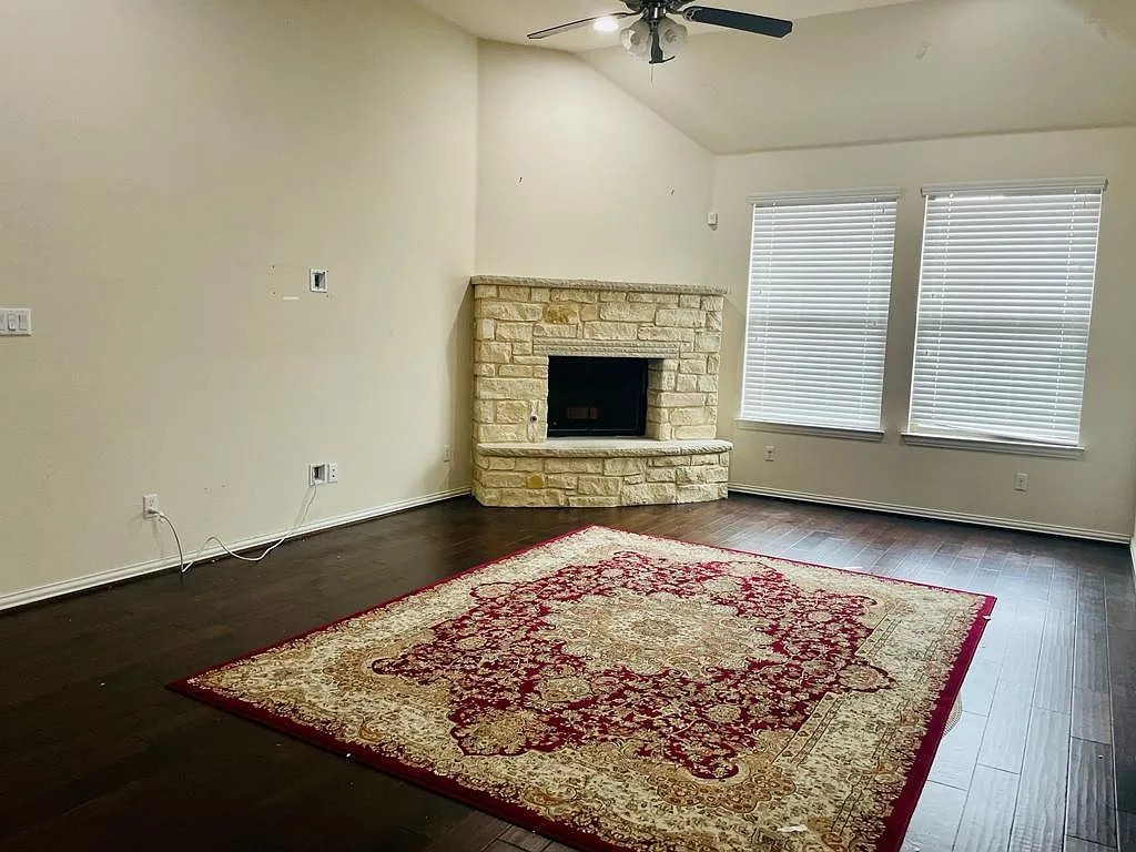 616 Garner Park Drive Georgetown, TX 78628 - Photo 13 of 26 Living area featuring dark wood-type flooring, vaulted ceiling, a fireplace, and ceiling fan