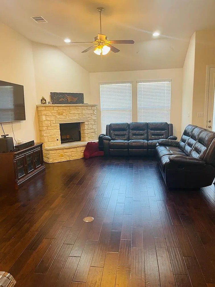 616 Garner Park Drive Georgetown, TX 78628 - Photo 25 of 26 Living area featuring a ceiling fan, dark wood-style flooring, vaulted ceiling, recessed lighting, and a stone fireplace