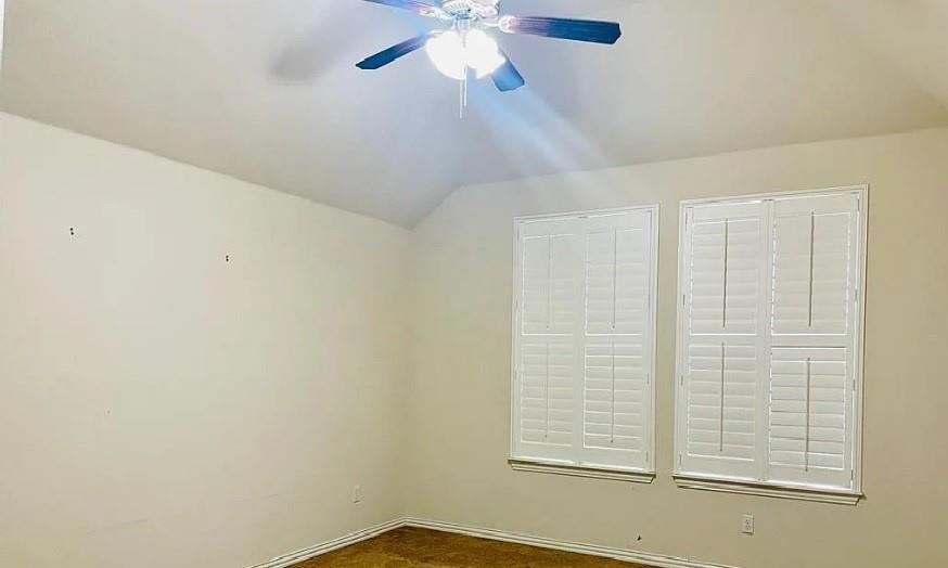 616 Garner Park Drive Georgetown, TX 78628 - Photo 7 of 26 Unfurnished room featuring lofted ceiling, a ceiling fan, and dark carpet