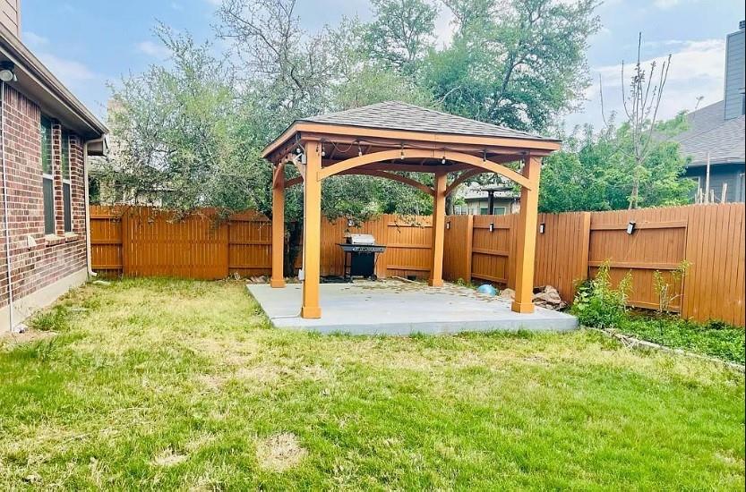 616 Garner Park Drive Georgetown, TX 78628 - Photo 10 of 26 Fenced backyard featuring a gazebo and a patio area
