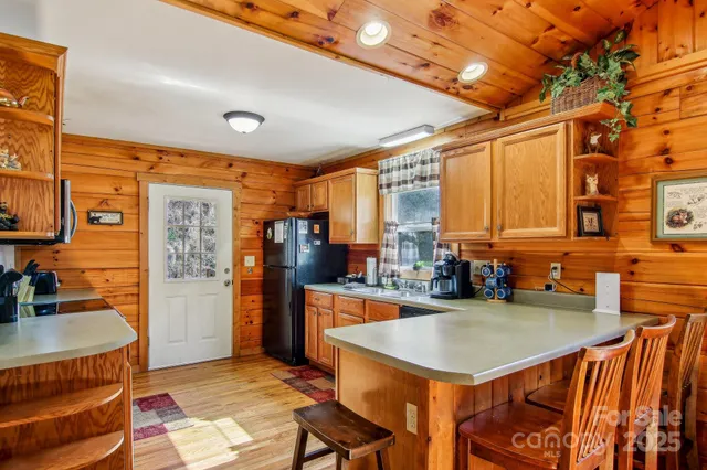 a kitchen with a table chairs and refrigerator