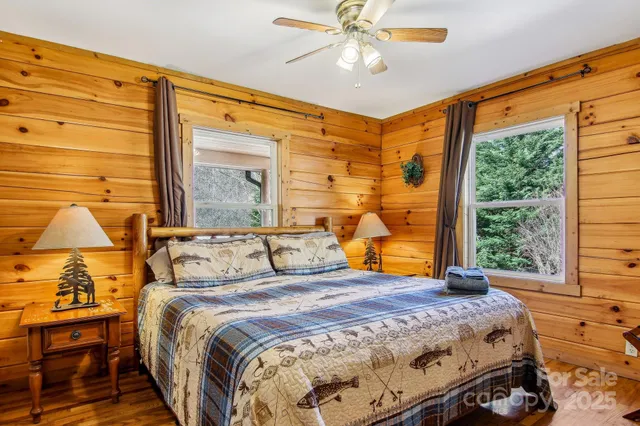 a bedroom with a large bed and a chandelier
