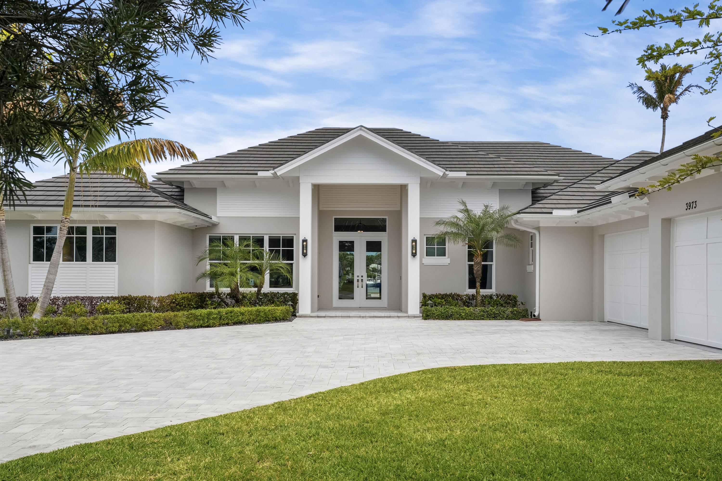 3973 Southeast Topsail Court Stuart, FL 34997 - Photo 38 of 38 a front view of a house with a yard and garage