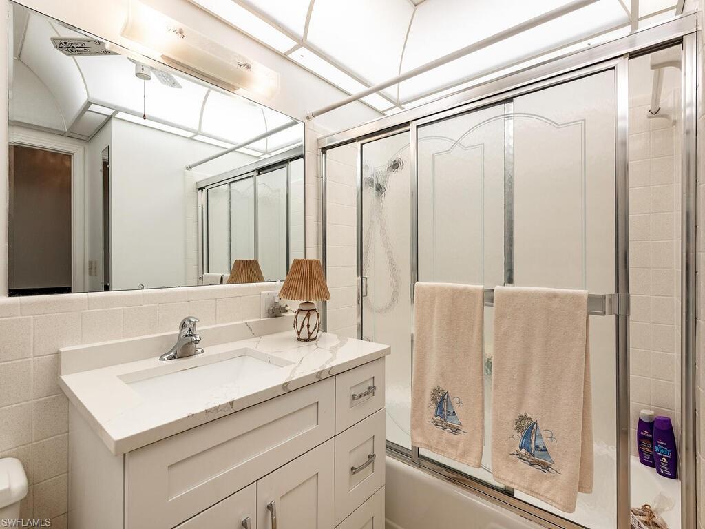 725 Pectin Road Naples, FL 34102 - Photo 12 of 13 Hall bathroom with tub/shower is in original part of home. In addition, the original second bath is off bedroom # 3 and has a walk-in shower.