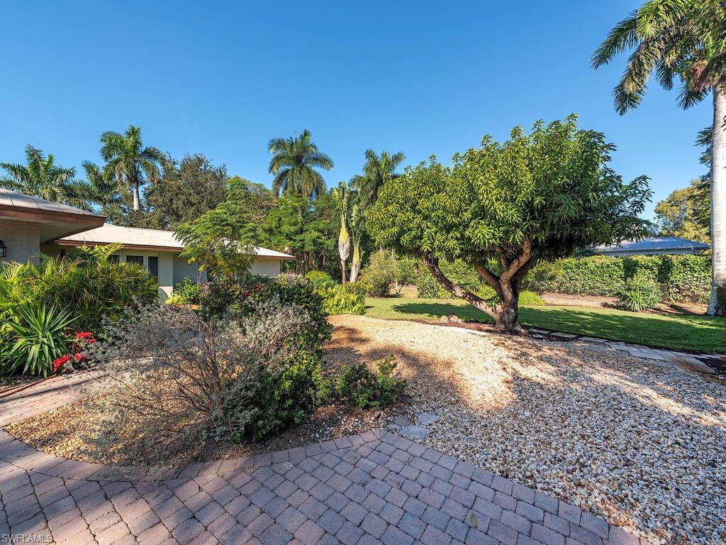 725 Pectin Road Naples, FL 34102 - Photo 4 of 13 Paver driveway to two car garage and additional parking in rear.