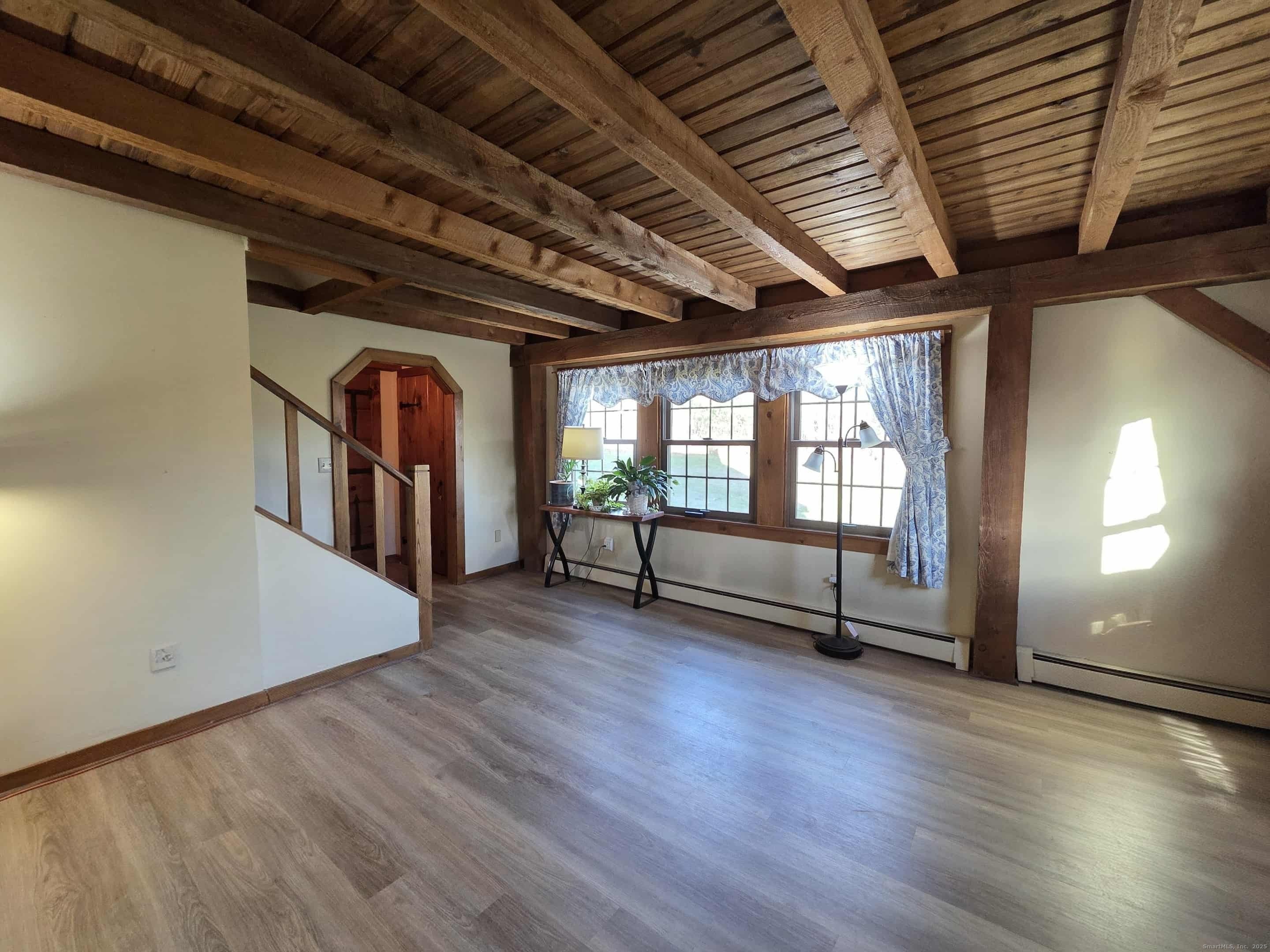 145 Perrin Road Woodstock, CT 06281 - Photo 11 of 38 a view of empty room with wooden floor and fan