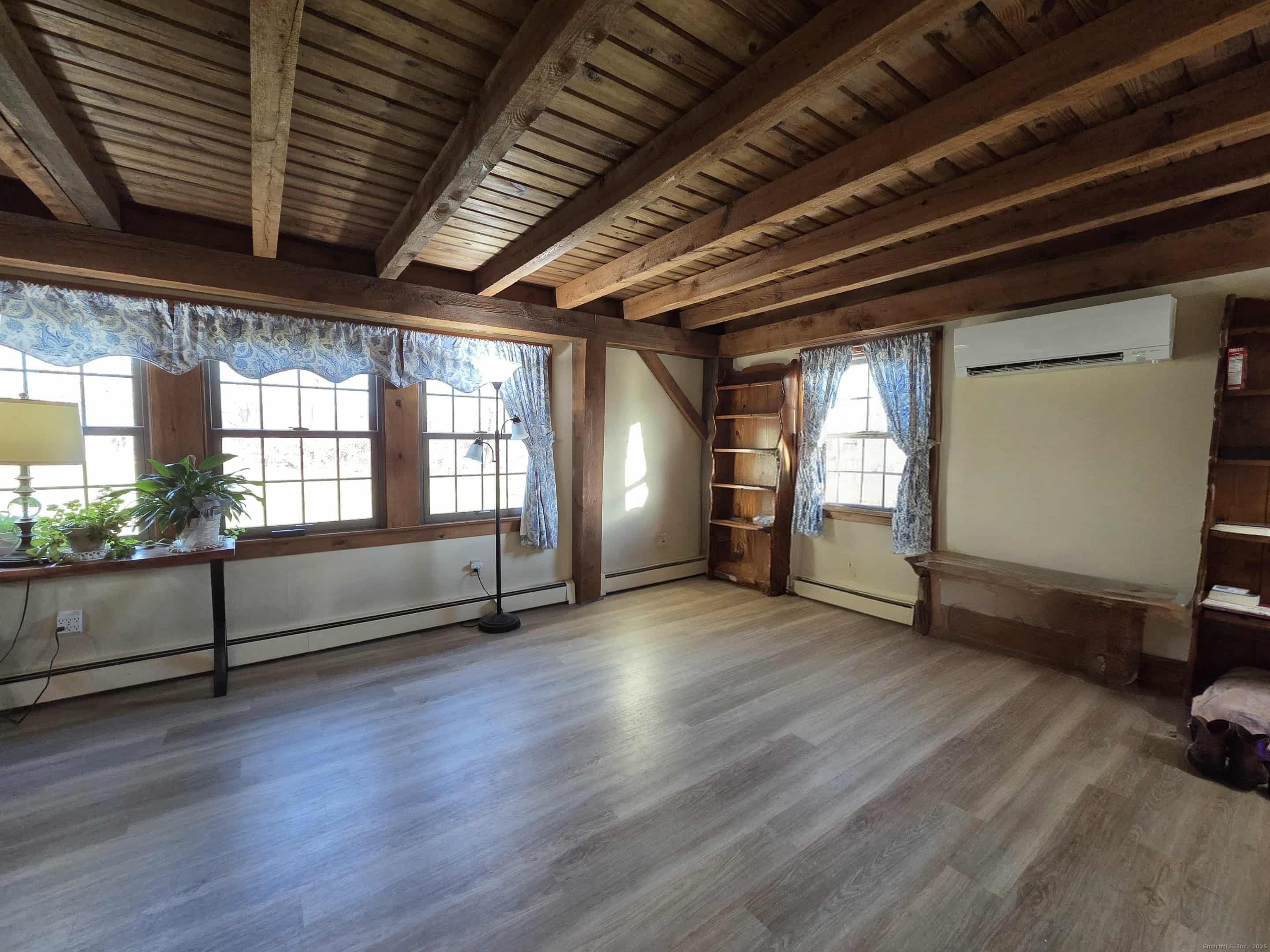 145 Perrin Road Woodstock, CT 06281 - Photo 12 of 38 an empty room with wooden floor and windows