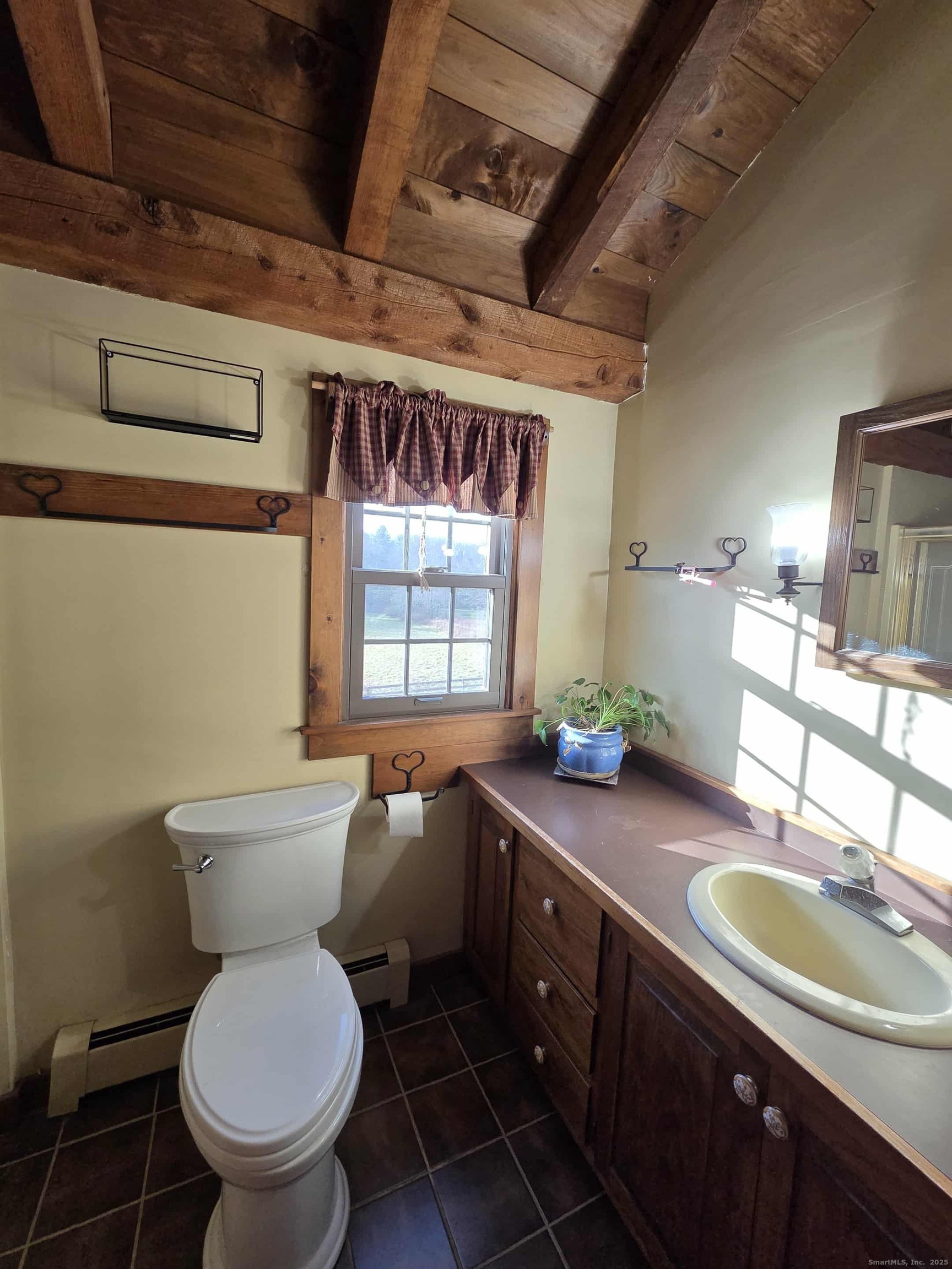 145 Perrin Road Woodstock, CT 06281 - Photo 17 of 38 a bathroom with a granite countertop toilet a sink and a large mirror