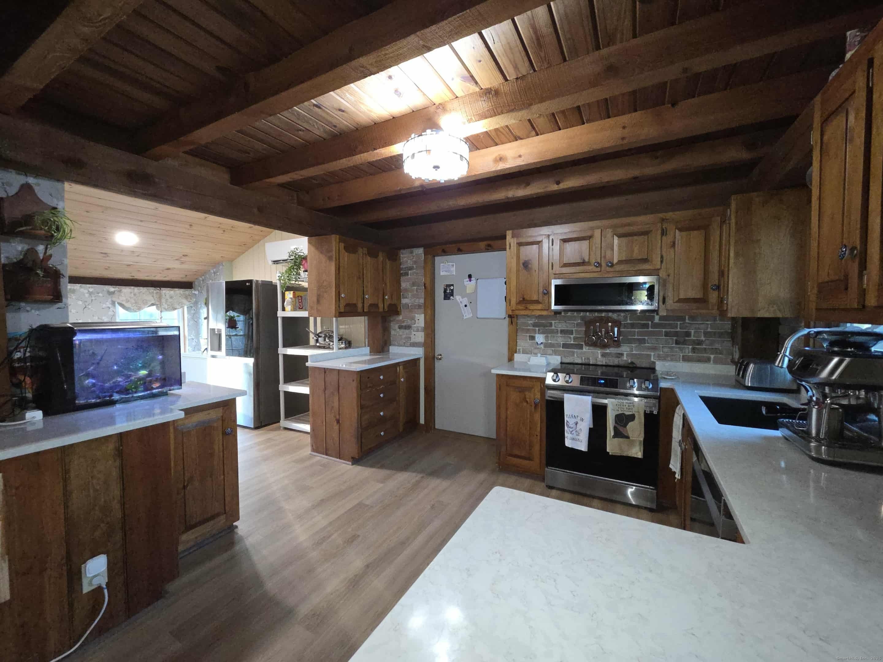 145 Perrin Road Woodstock, CT 06281 - Photo 2 of 38 a kitchen with stainless steel appliances kitchen island granite countertop a stove sink and cabinets